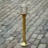 Nautical style brass bollard light with transparent glass for coastal areas