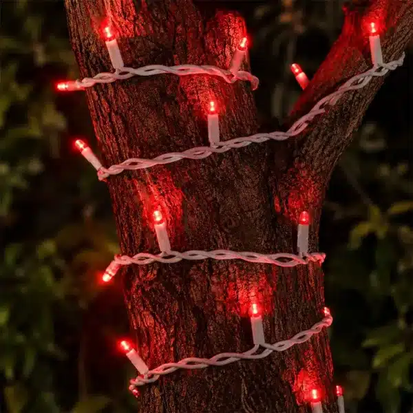 Connectable red outdoor Christmas lights white cable wrapped on tree