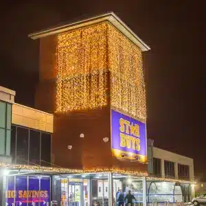 LED curtain lights 6m drop in warm white with ice white flash side angle on Star Buys building