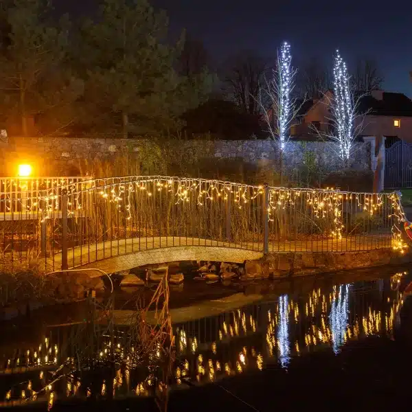 Outdoor LED icicle Christmas lights warm white on railings