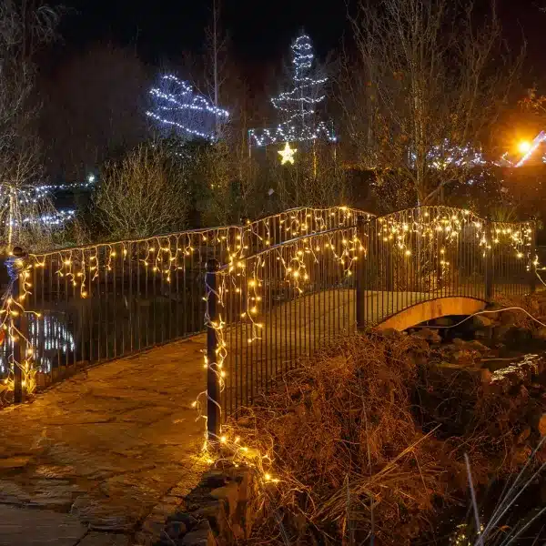 Outdoor LED icicle Christmas lights warm white on railings display