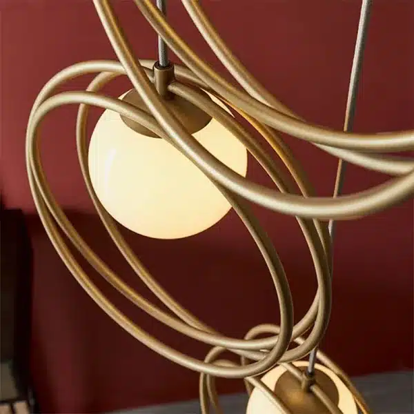 Brushed gold pendant light with opal glass shades rings design
