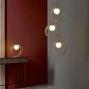 Brushed gold pendant light with opal glass shades in living room