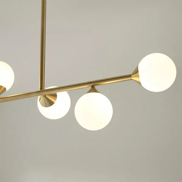 Modern satin brass linear bar pendant light with glass shades close up