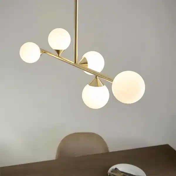 Modern satin brass linear bar pendant light with glass shades side view