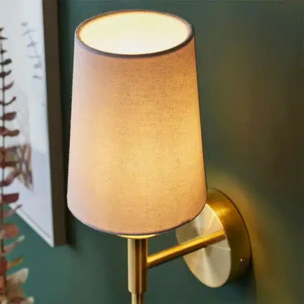 Satin brass wall light fabric shade close up