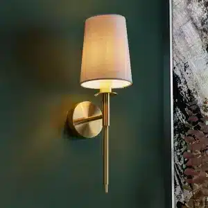 Satin brass wall light with vintage white shade product close up