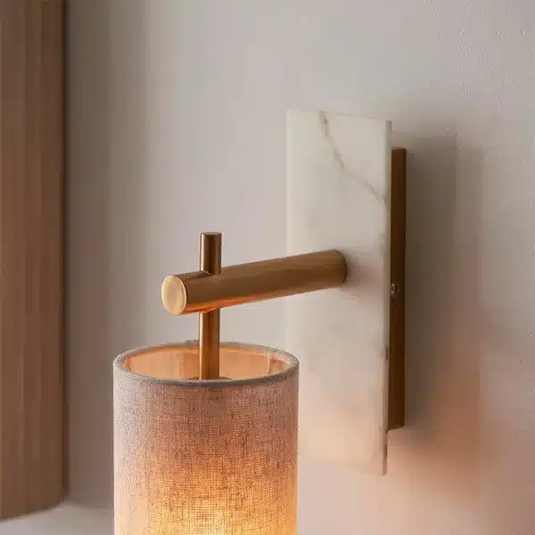 Modern brass marble effect wall light close up downwards