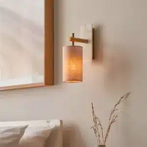 Brass and marble effect wall light mounted facing downward close up