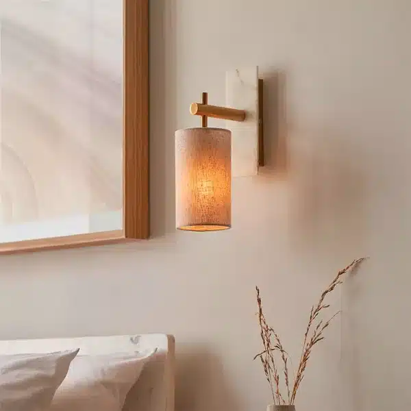 Brass and marble effect wall light mounted facing downward close up
