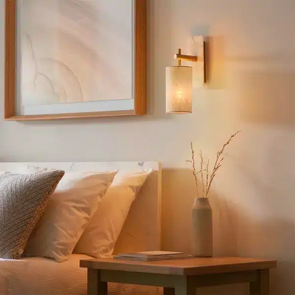 Modern brass and marble effect wall light mounted facing downward in bedroom