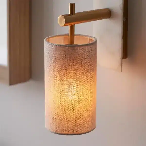 Modern brass marble effect wall light with linen shade close up