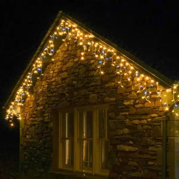 Connectable triangle icicle lights in warm white with ice white flash, feature 192 LEDs roofline display