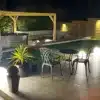 Garden lighting ideas with outdoor ball lamps, wall lights and patio seating in an Irish garden
