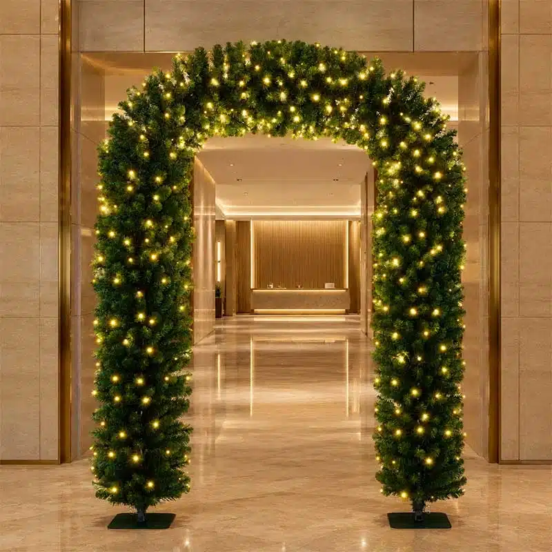 2.4m-Pre-Lit-Evergreen-Christmas-Entrance-Arch-at-Entrance 2.4m pre-lit evergreen Christmas arch displayed at a hotel entrance