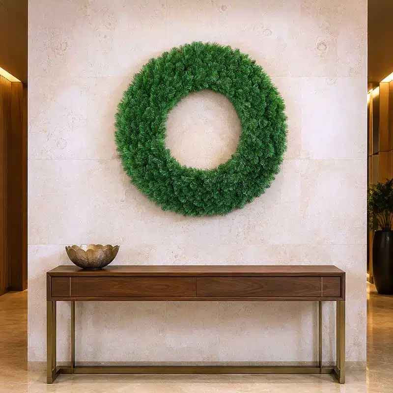 90cm-non-lit-Alaskan-pine-Christmas-wreath-displayed-on-wall 90cm non-lit Alaskan pine Christmas wreath displayed on a hotel lobby feature wall