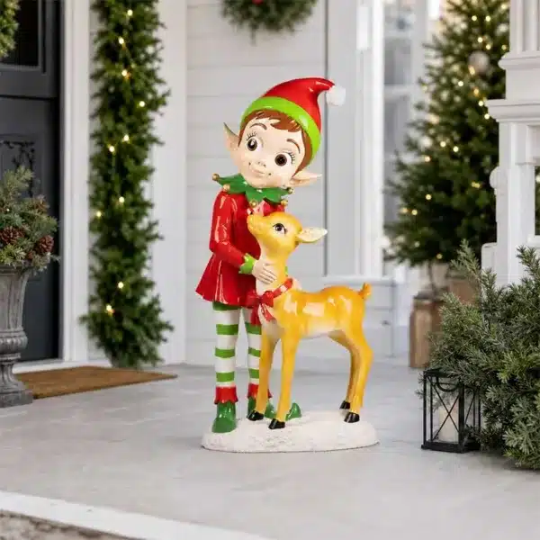 Large festive elf standing beside a reindeer on a snow-effect base