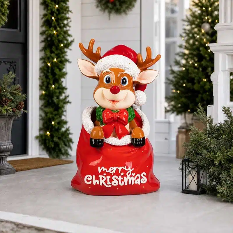 Funny-deer-sitting-in-Christmas-sack-decoration Funny Christmas reindeer sitting in a red Merry Christmas sack at entrance